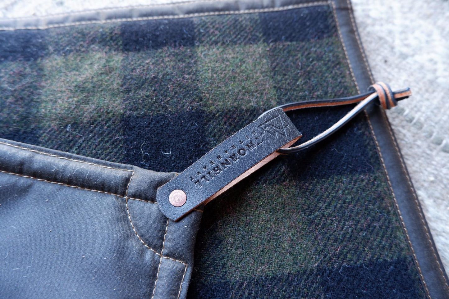 Padded sit-pad, checked wool & waxed canvas with leather tie-out