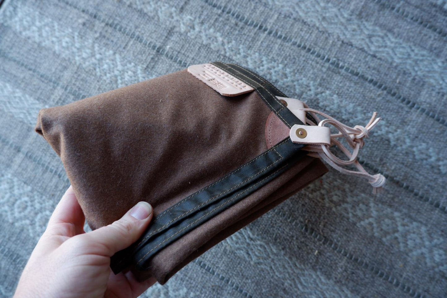 Wool lined sit-pad, waxed canvas-backed with leather tie-outs