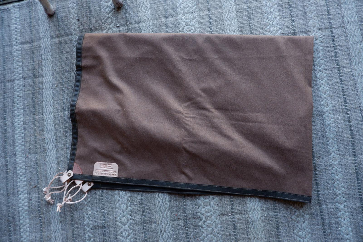 Wool lined sit-pad, waxed canvas-backed with leather tie-outs