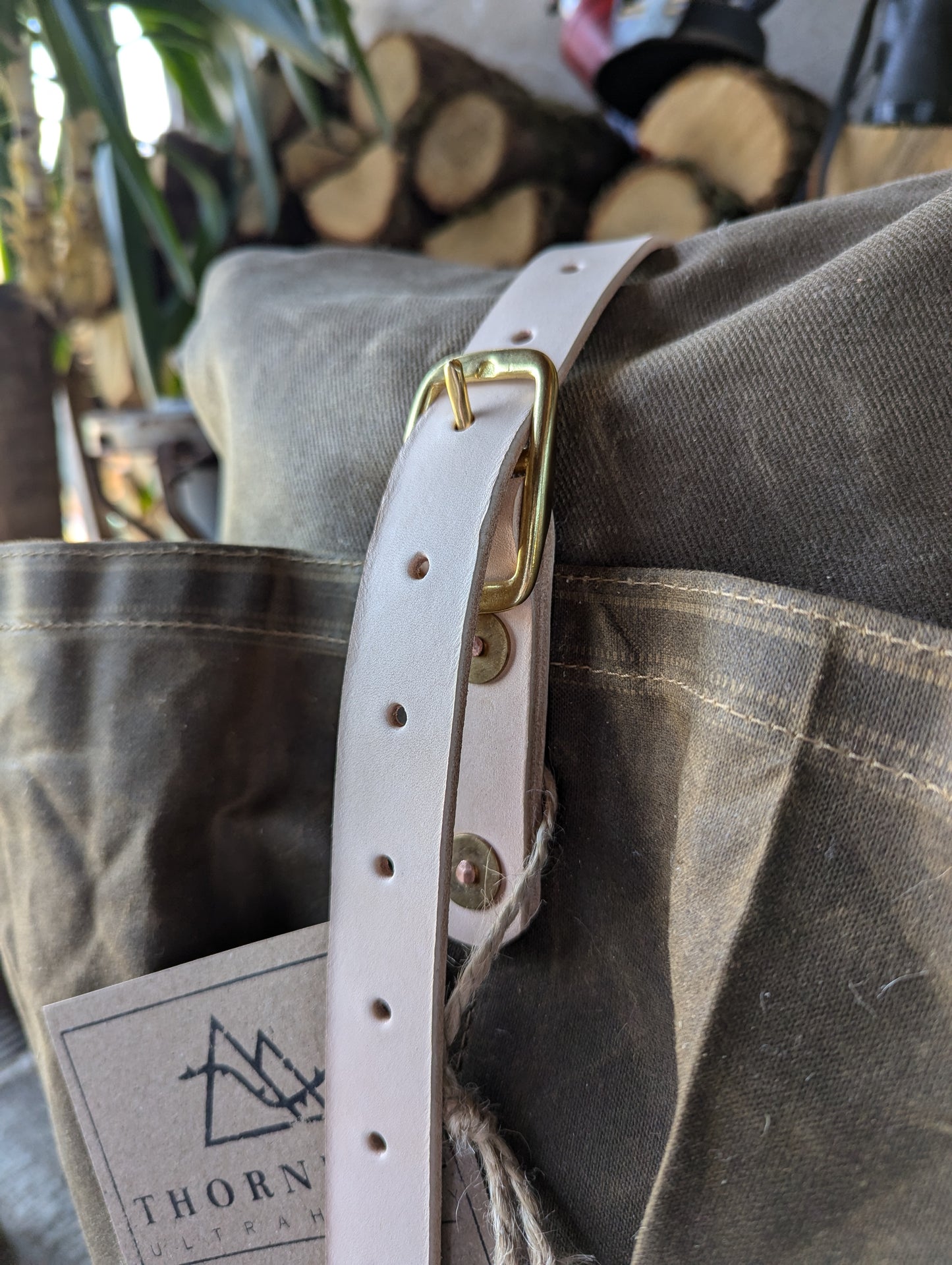 Lashing straps - brass buckled leather bag straps