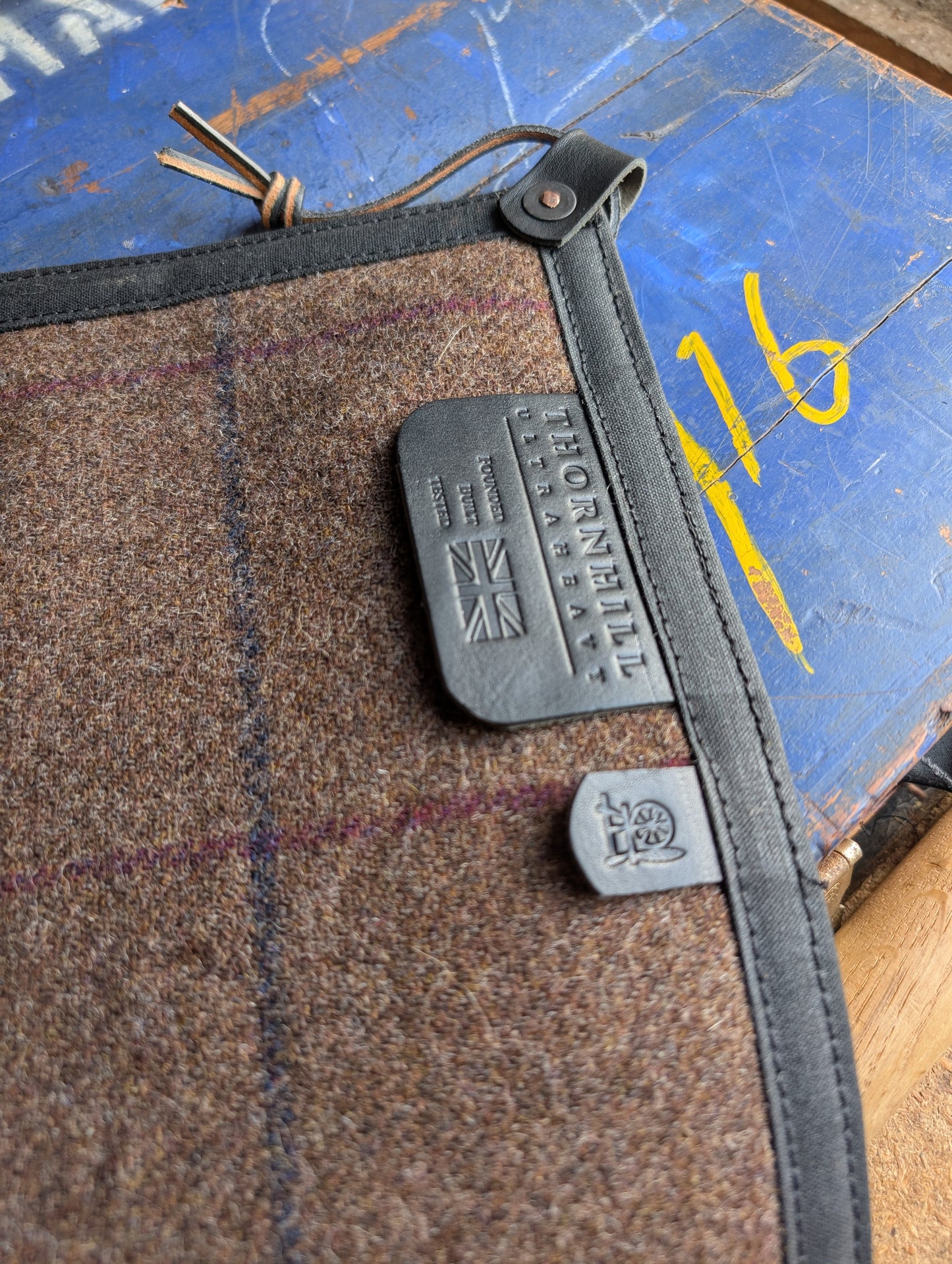Padded sit-pad, checked wool & waxed canvas with leather tie-out